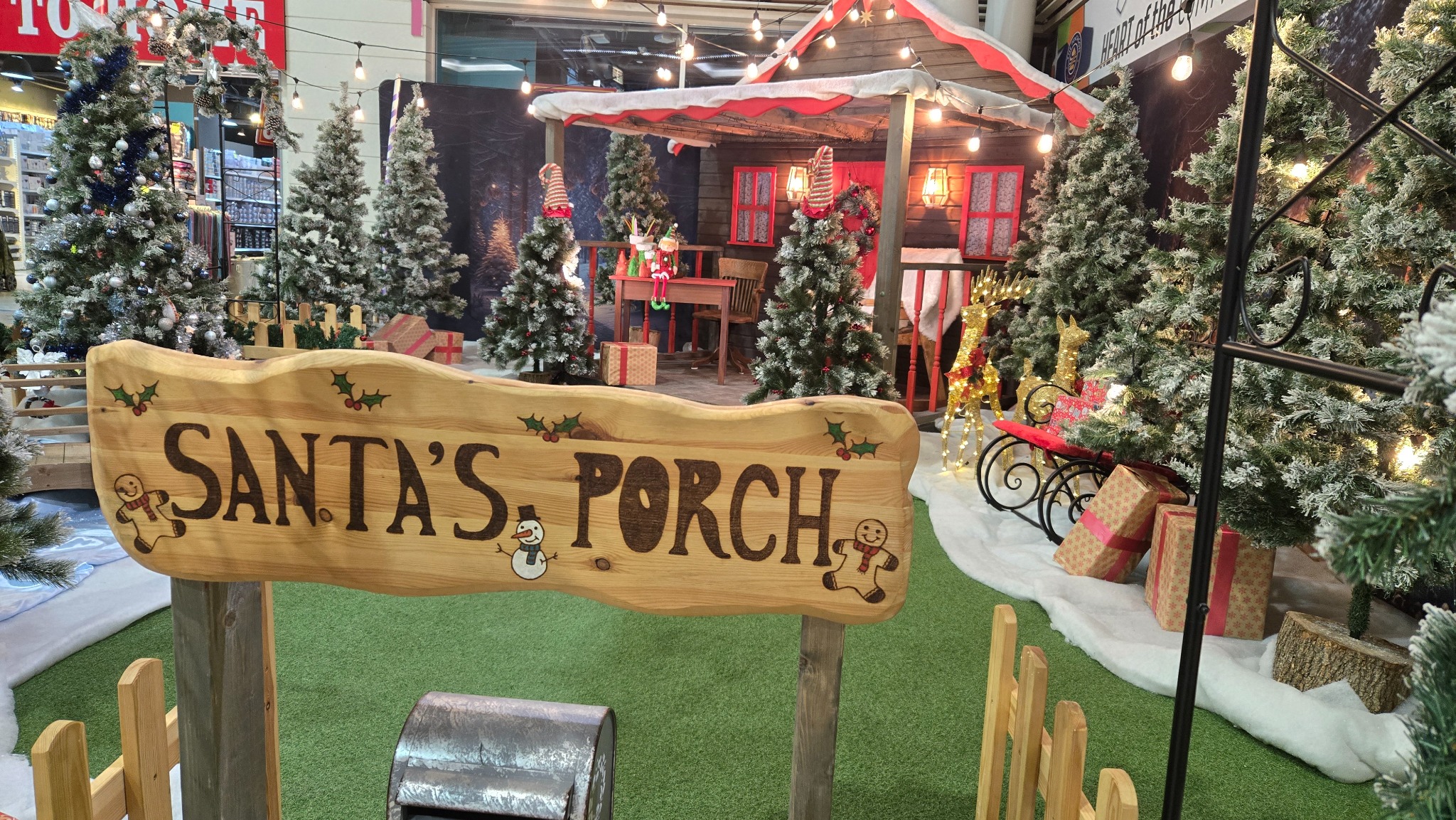 Santa’s Porch grotto at Pentagon Shopping Centre, surrounded by snowy Christmas trees and festive lights
